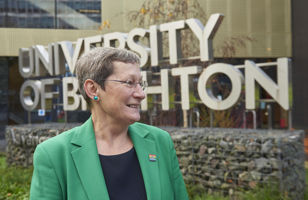 Professor Debra Humphris in front of the ϲʹ sign